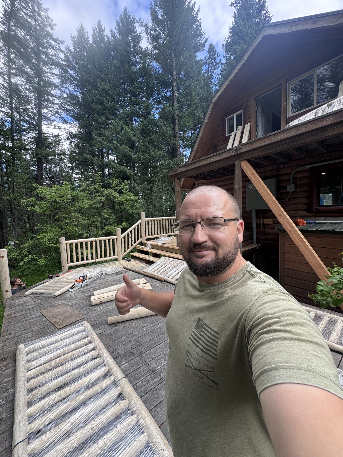 Dennis Bontrager installing custom log railing, Hungry Horse MT
