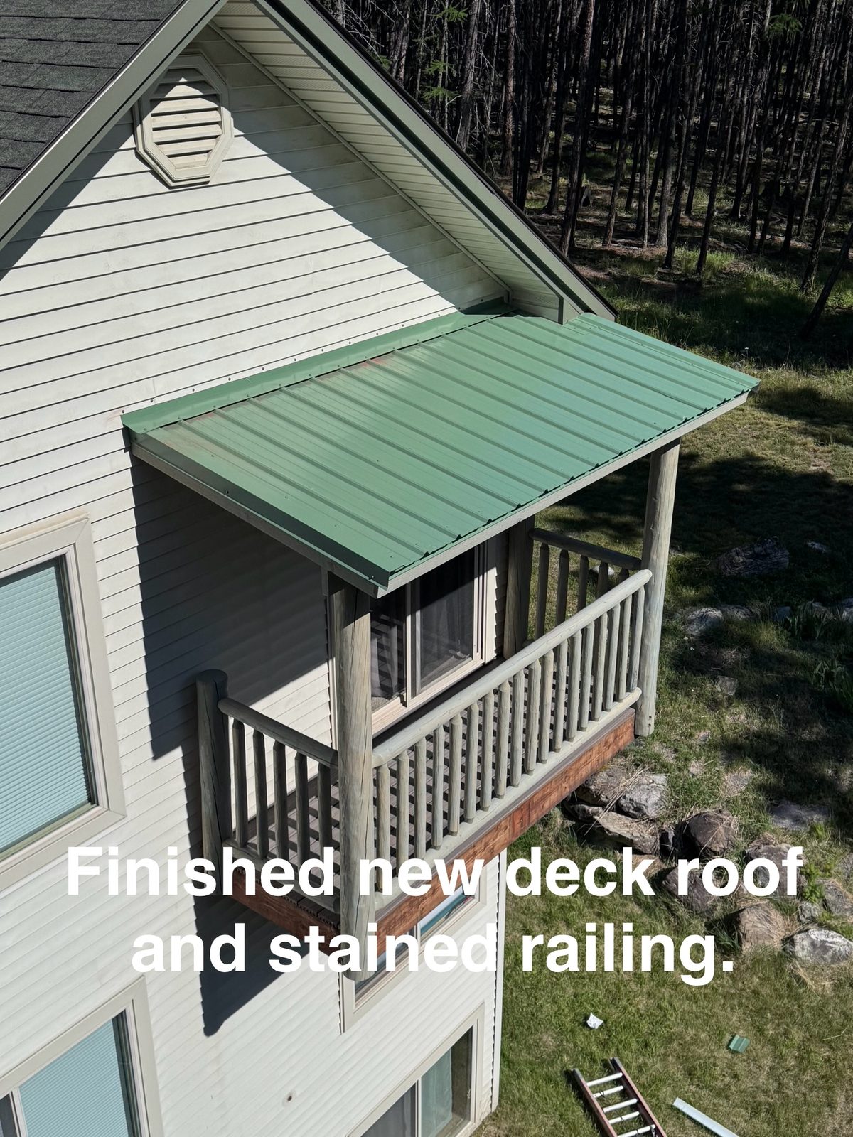Finished deck with new metal roof and stained railing, Kalispell MT