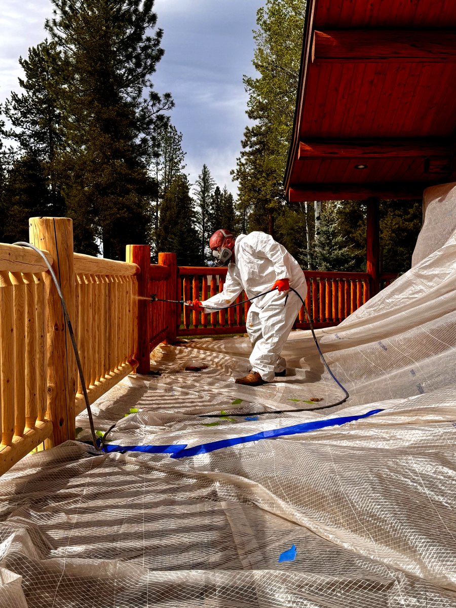 Dennis Bontrager staining log home railing Northwest Montana